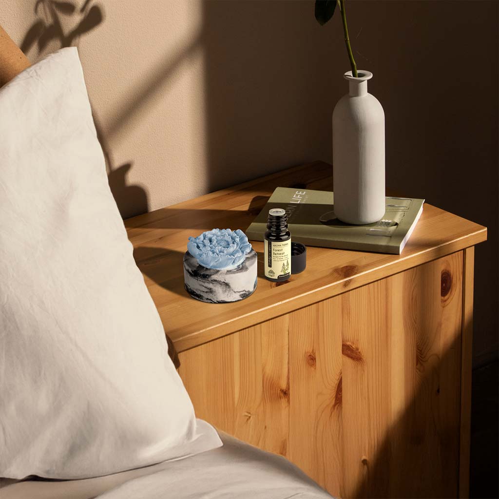 cera flora blue flower ceramic diffuser with essential oil on bedside table