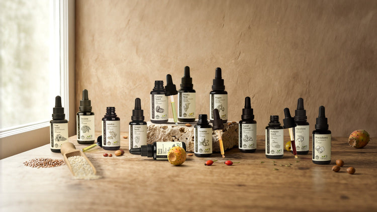Pure organic carrier oils collection including Jojoba, Rosehip, Argan, Almond and Prickly Pear in violet glass bottles