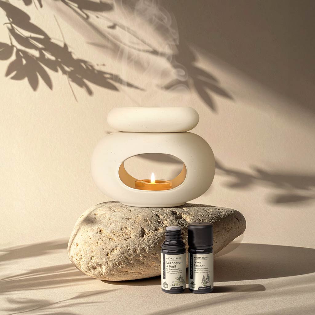 Aroma Tierra Lona ceramic candle burner on natural stone with Lemongrass & Basil and Forest Retreat essential oils