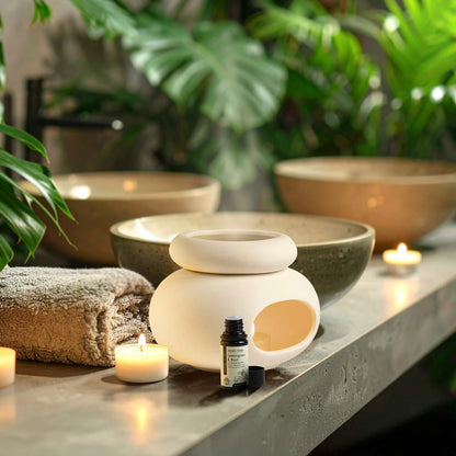 Aroma Tierra Lona ceramic candle burner diffuser in spa setting with Lemongrass & Basil essential oil and candles